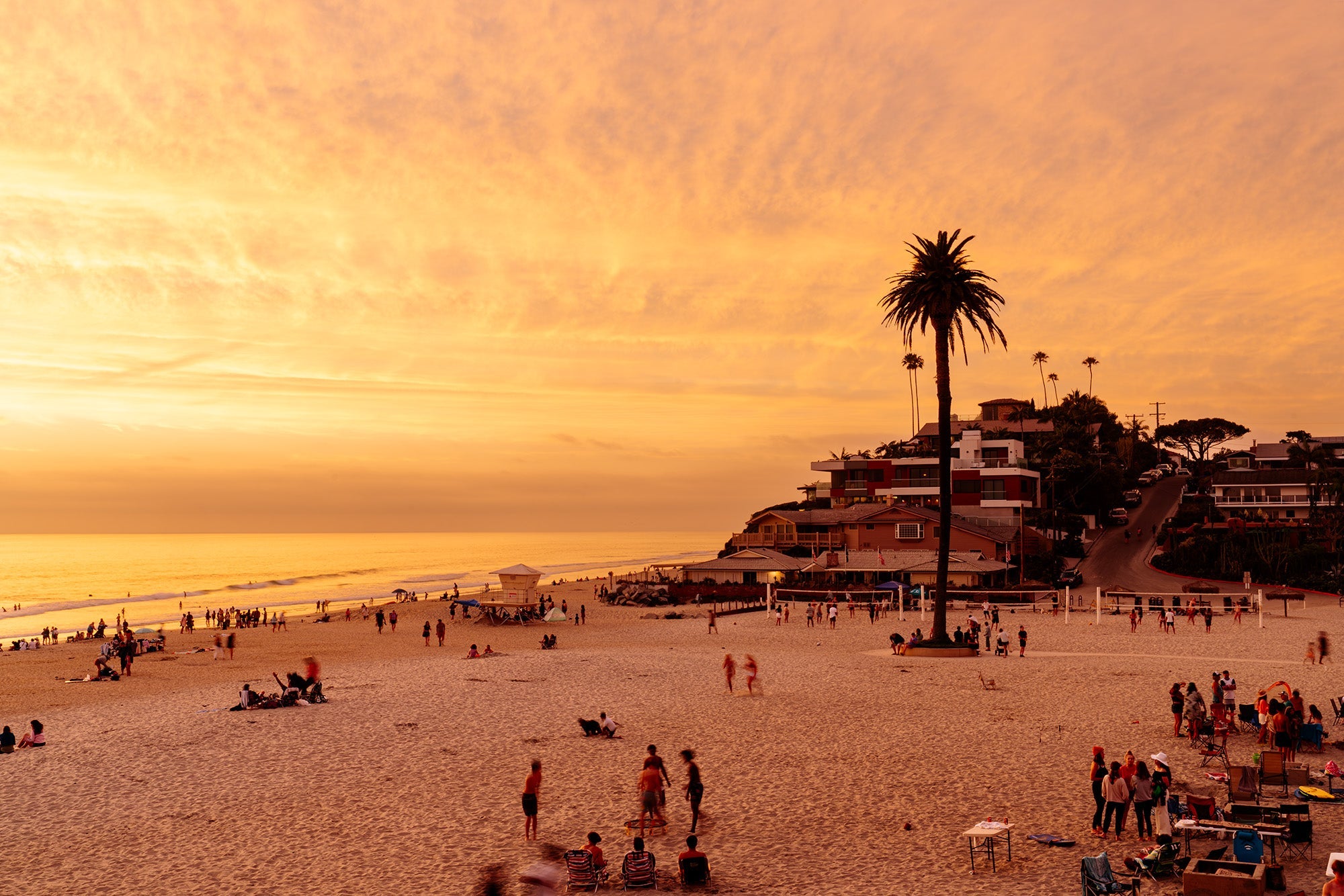 Encinitas beach with surfers and smiling people enjoying sand and surf