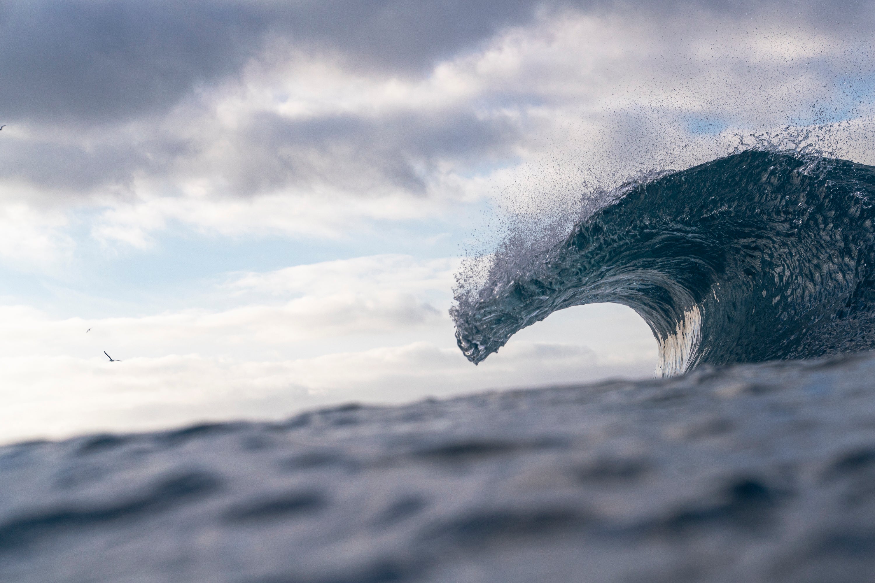 Wave crashing against a cloudy sky. Laguna Beach, California. 