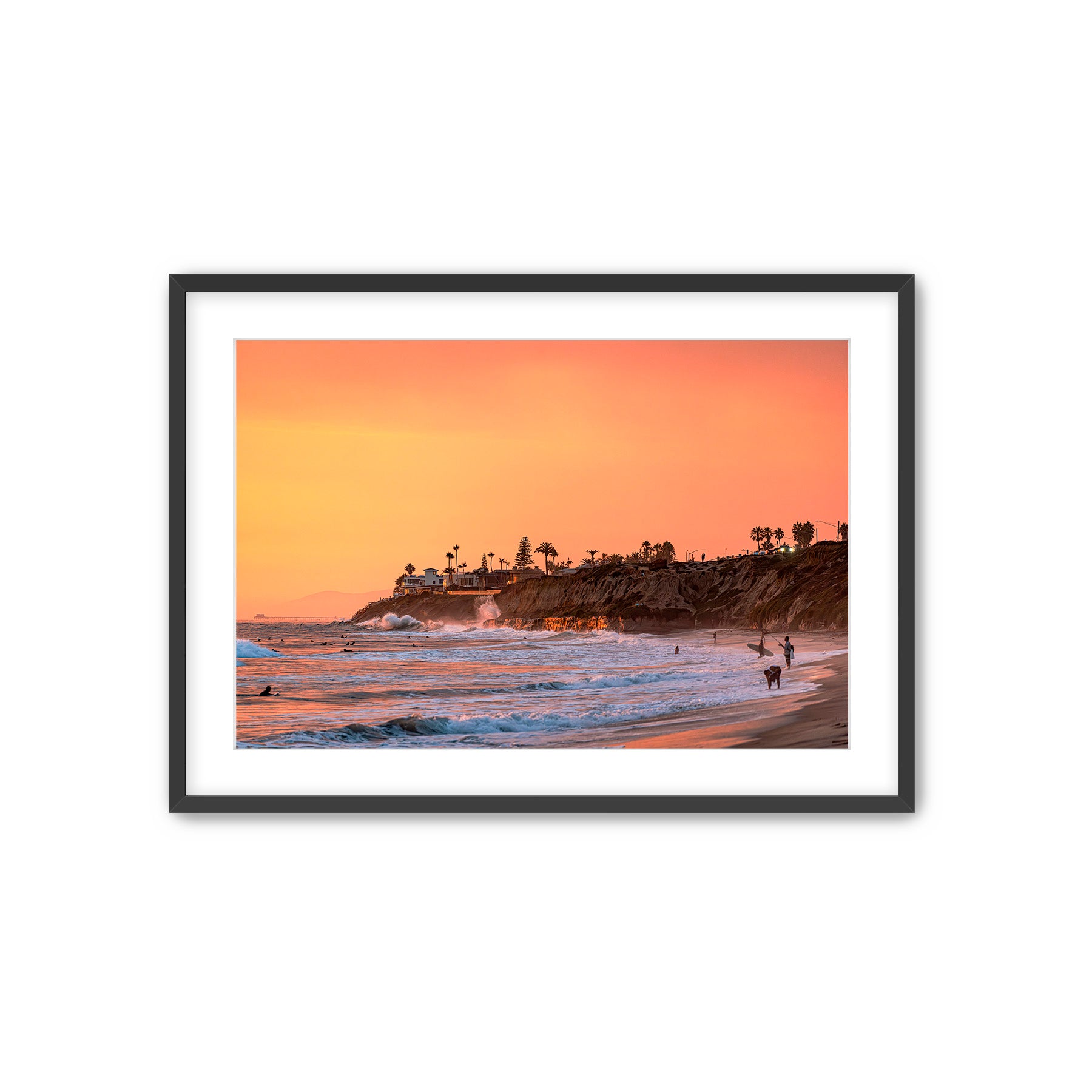 Framed artwork of a Carlsbad beach scene with a sunset over the Pacific ocean.