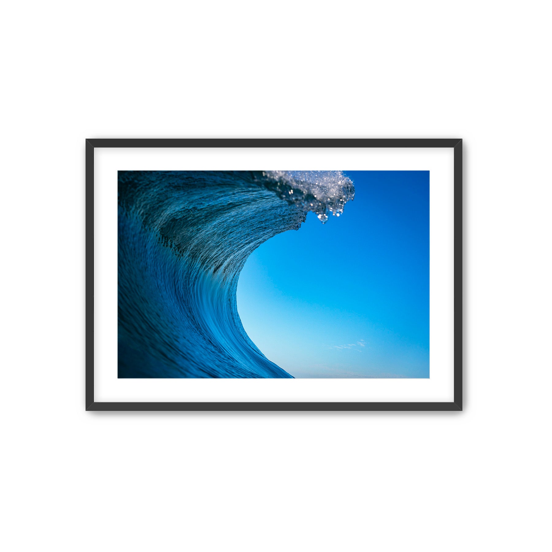 Framed photograph of a blue wave with clear sky, forming the letter C.
