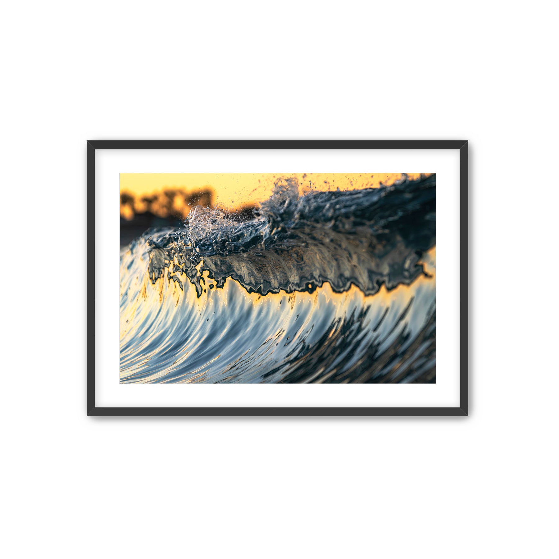Framed artwork of a colorful wave crashing on Tamarack beach with a sunrise in the background.