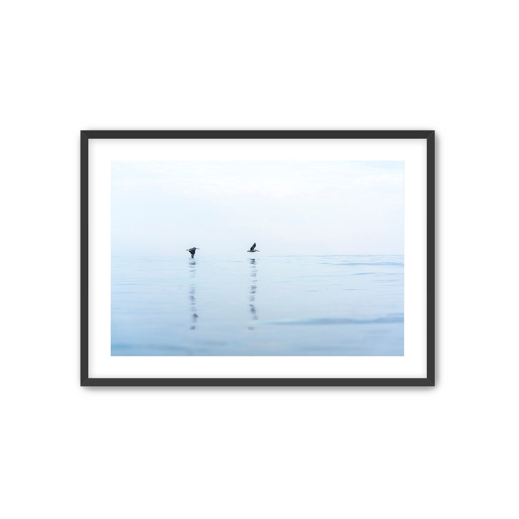 Framed artwork of two birds on a misty lake with a black frame.