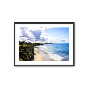 Framed photograph of Carlsbad beach with cliffs and ocean view. 