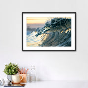 Framed photograph of a wave like a jewel on a wall above a desk with office supplies.