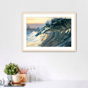 Framed photograph of a wave like a jewel on a wall above a desk with office supplies.