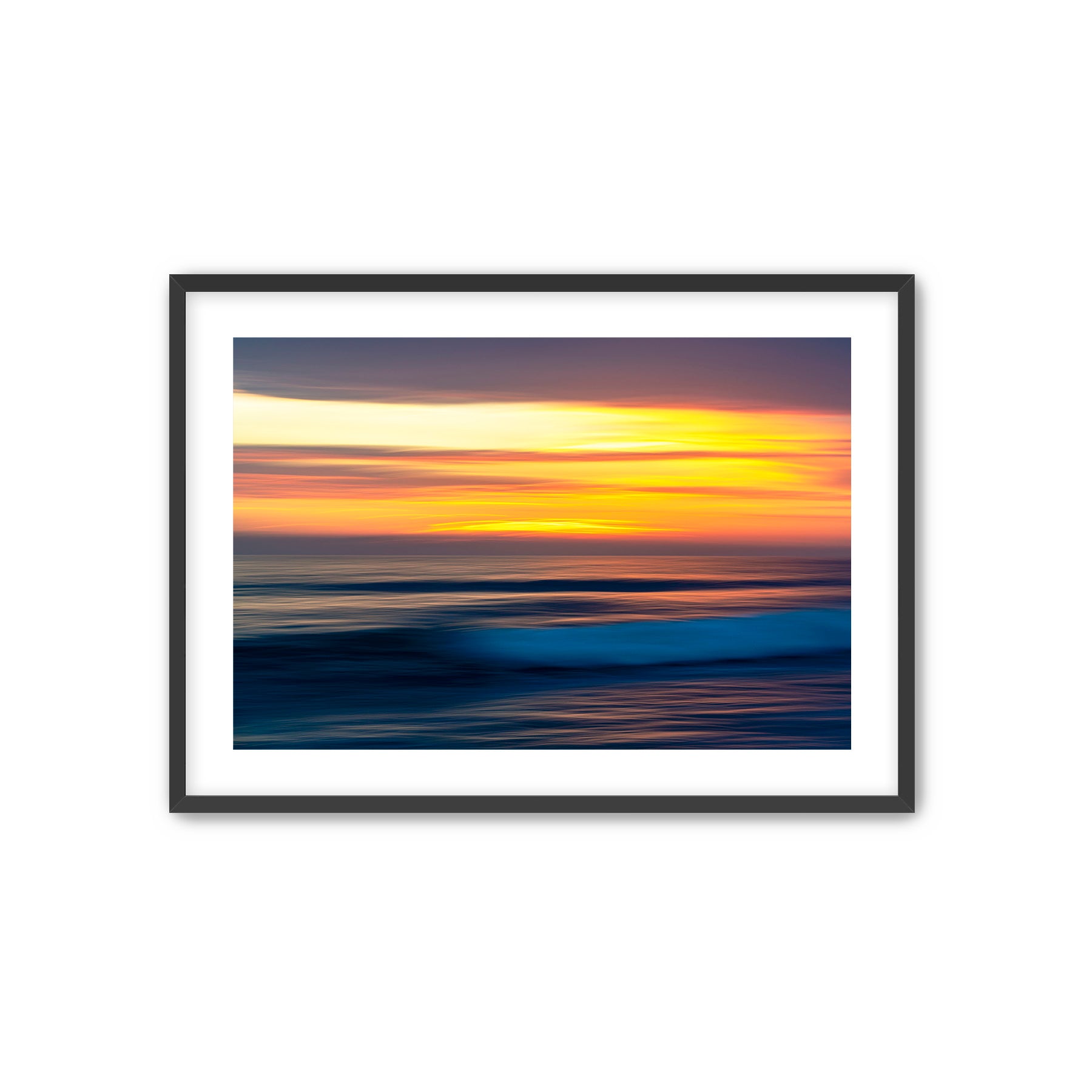 Framed artwork of a sunset over water with a black frame.