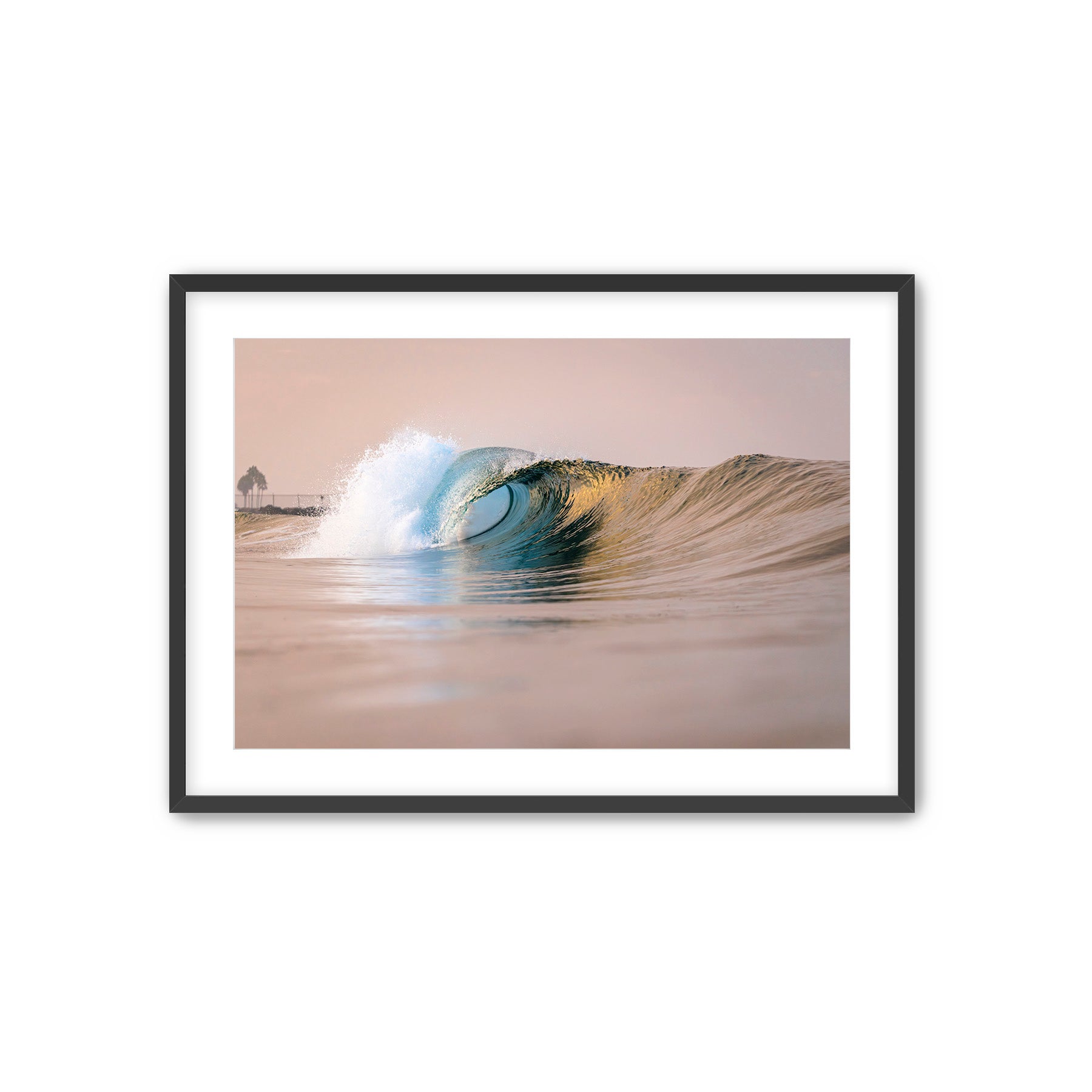 Framed photograph of a wave curling in water with a black frame.