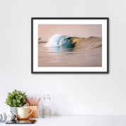 Framed artwork of a warm wave on a wall above a desk with office supplies. South Carlsbad State Beach, Carlsbad, California. 