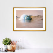 Framed artwork of a warm wave on a wall above a desk with office supplies. South Carlsbad State Beach, Carlsbad, California. 