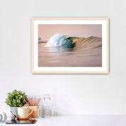 Framed artwork of a warm wave on a wall above a desk with office supplies. South Carlsbad State Beach, Carlsbad, California. 