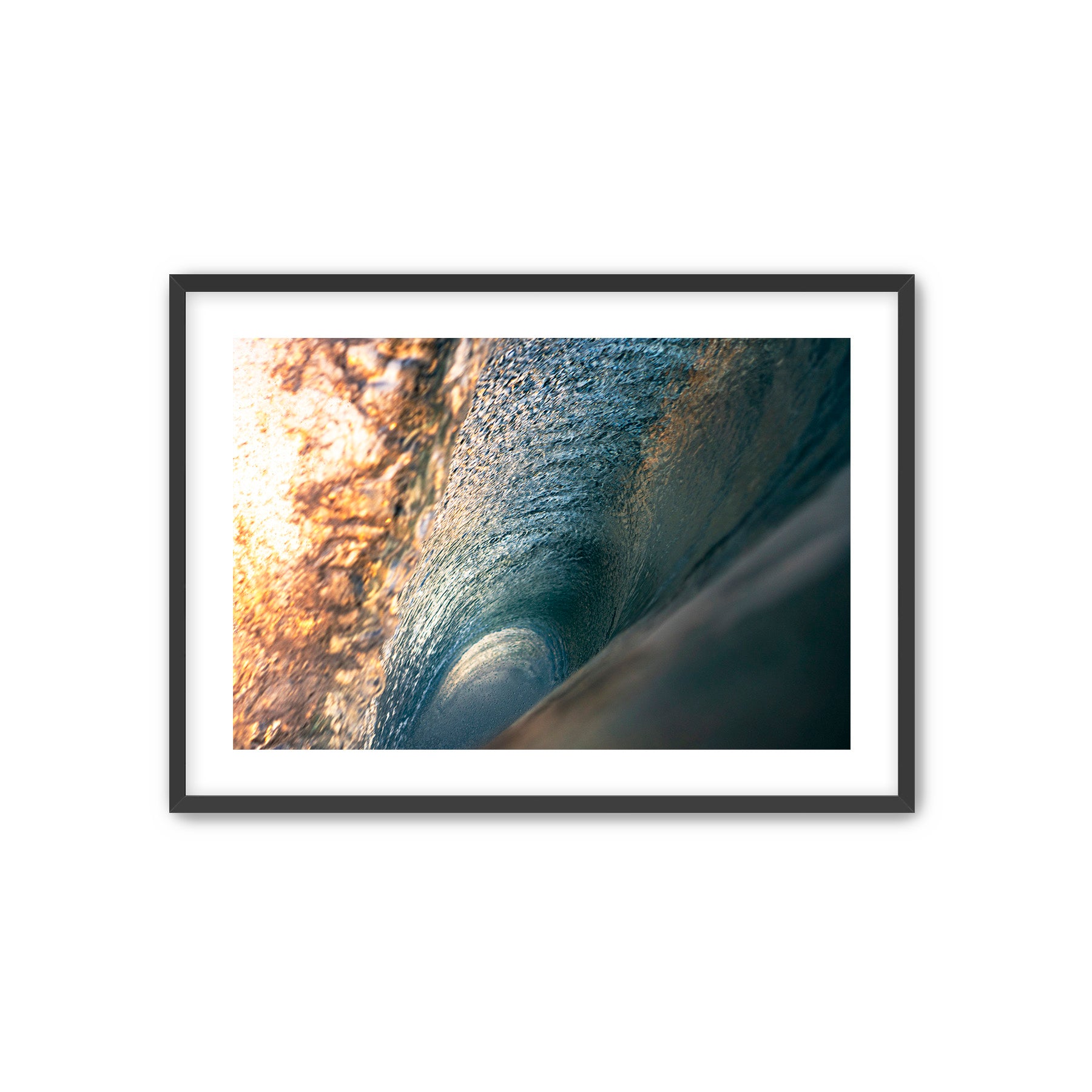 Framed photograph of a wave with sunlight filtering through.